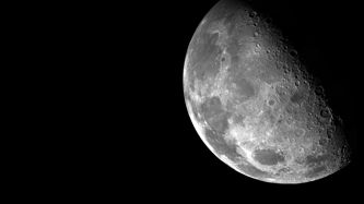 Close-up view of the moon's surface, showing detailed craters and textures.